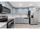 Modern kitchen featuring stainless steel appliances and sleek gray cabinets at 4939 18Th St, Zephyrhills, FL 33542
