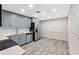 Modern kitchen with gray cabinetry, stainless steel appliances, and white countertops at 4939 18Th St, Zephyrhills, FL 33542