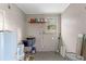 Laundry room or utility area with a sink, water heater, storage shelf, and various supplies at 4939 18Th St, Zephyrhills, FL 33542