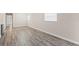 Living room with wood-look flooring, neutral walls, and natural light at 4939 18Th St, Zephyrhills, FL 33542