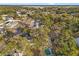 High angle view of a neighborhood with houses, trees, roads, and airport in distance at 4939 18Th St, Zephyrhills, FL 33542