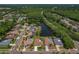Aerial view showcases homes nestled amongst trees and ponds in a peaceful residential community at 591 Waterford W Cir, Tarpon Springs, FL 34688
