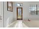 Bright foyer with tiled floor, stained-glass door, and carpeted living space at 591 Waterford W Cir, Tarpon Springs, FL 34688