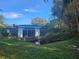 Backyard view of home with pool and lush landscaping at 7222 N Ola Ave, Tampa, FL 33604