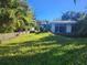 Overgrown backyard with two houses. Needs landscaping at 7222 N Ola Ave, Tampa, FL 33604