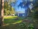 Large backyard with two houses and overgrown grass at 7222 N Ola Ave, Tampa, FL 33604