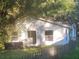 Cozy cottage nestled in a lush backyard with a wooden fence at 7222 N Ola Ave, Tampa, FL 33604