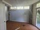Simple bedroom with wood floors and stone accent wall at 7222 N Ola Ave, Tampa, FL 33604