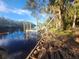 Damaged boat dock on calm river with surrounding trees at 7222 N Ola Ave, Tampa, FL 33604