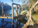 Damaged boat on rustic lift at waterfront dock at 7222 N Ola Ave, Tampa, FL 33604