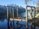 Damaged boat lift in calm water, trees in background at 7222 N Ola Ave, Tampa, FL 33604