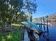 Damaged boat at a partially destroyed wooden dock at 7222 N Ola Ave, Tampa, FL 33604