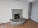 Stone fireplace in a room with light wood floors at 7222 N Ola Ave, Tampa, FL 33604