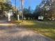 Landscaped front yard with mature trees and a long driveway at 7222 N Ola Ave, Tampa, FL 33604