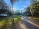 Home exterior with a driveway and mature landscaping at 7222 N Ola Ave, Tampa, FL 33604
