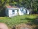 Small white house with a chain link fence at 7222 N Ola Ave, Tampa, FL 33604