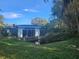 Ranch-style home with a pool and overgrown vegetation at 7222 N Ola Ave, Tampa, FL 33604