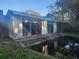 White house with large windows near a pond at 7222 N Ola Ave, Tampa, FL 33604