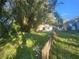 Small house exterior with overgrown yard and fence at 7222 N Ola Ave, Tampa, FL 33604