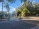 Street view of property with mature trees and a gated entrance at 7222 N Ola Ave, Tampa, FL 33604