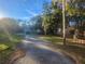 Street view of property with mature trees and a gated entrance at 7222 N Ola Ave, Tampa, FL 33604