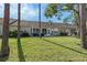 Large backyard with grassy area and trees at 7423 Woodhollow Rd, Spring Hill, FL 34606