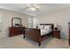 Spacious bedroom with sleigh bed, dresser, and ceiling fan at 7423 Woodhollow Rd, Spring Hill, FL 34606