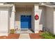Inviting entryway with a bright blue double door and festive wreath at 7423 Woodhollow Rd, Spring Hill, FL 34606