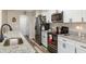 Updated kitchen with granite countertops and stainless steel appliances at 7423 Woodhollow Rd, Spring Hill, FL 34606