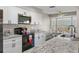 Updated kitchen, granite counters, white cabinets, and stainless steel appliances at 7423 Woodhollow Rd, Spring Hill, FL 34606