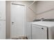 Laundry room with washer, dryer, and extra storage space at 7423 Woodhollow Rd, Spring Hill, FL 34606