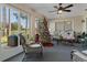 Bright sunroom with wicker furniture, Christmas tree, and view of the backyard at 7423 Woodhollow Rd, Spring Hill, FL 34606