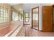 Pink bathroom with large tub, glass block window, and tiled floor at 7443 Oak Tree Ln, Spring Hill, FL 34607
