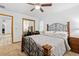 Bedroom featuring wooden bed frame, desk, mirrored closet doors, and ceiling fan at 7443 Oak Tree Ln, Spring Hill, FL 34607