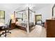 Bedroom with canopy bed, ceiling fan, and tile floor at 7443 Oak Tree Ln, Spring Hill, FL 34607