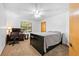 Bedroom with black bed frame, desk, ceiling fan, and carpeted floor at 7443 Oak Tree Ln, Spring Hill, FL 34607