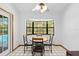 Breakfast nook with round table and chairs, and view of pool through window at 7443 Oak Tree Ln, Spring Hill, FL 34607
