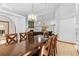 Open concept dining and living room with tile floors and chandelier at 7443 Oak Tree Ln, Spring Hill, FL 34607