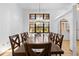 Dining room with wood table, chairs, and view of outdoors through window at 7443 Oak Tree Ln, Spring Hill, FL 34607
