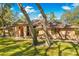 Exterior view of a home with a brown roof, brick accents, and mature trees at 7443 Oak Tree Ln, Spring Hill, FL 34607