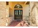Welcoming front entry with a dark wood double door and brick accents at 7443 Oak Tree Ln, Spring Hill, FL 34607