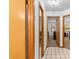 Hallway with mirrored closet doors and access to other rooms at 7443 Oak Tree Ln, Spring Hill, FL 34607