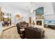 Large living room with fireplace, leather furniture, and high ceilings at 7443 Oak Tree Ln, Spring Hill, FL 34607