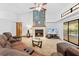 Living room with a fireplace, sliding glass doors, and view of the backyard at 7443 Oak Tree Ln, Spring Hill, FL 34607