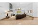 Open living area with a fireplace, leather sectional, and tile floor at 7443 Oak Tree Ln, Spring Hill, FL 34607