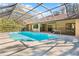 Spacious screened-in pool with surrounding patio at 7443 Oak Tree Ln, Spring Hill, FL 34607