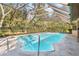 Inviting screened-in pool perfect for relaxation at 7443 Oak Tree Ln, Spring Hill, FL 34607