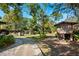 Backyard featuring a wooden shed, mature trees, and a walkway at 7600 138Th St, Seminole, FL 33776