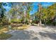 Spacious backyard featuring a pond and custom brick fireplace, ideal for outdoor relaxation at 7600 138Th St, Seminole, FL 33776