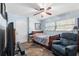 Guest bedroom with blue walls, a ceiling fan, and a comfortable chair for relaxing in at 7600 138Th St, Seminole, FL 33776